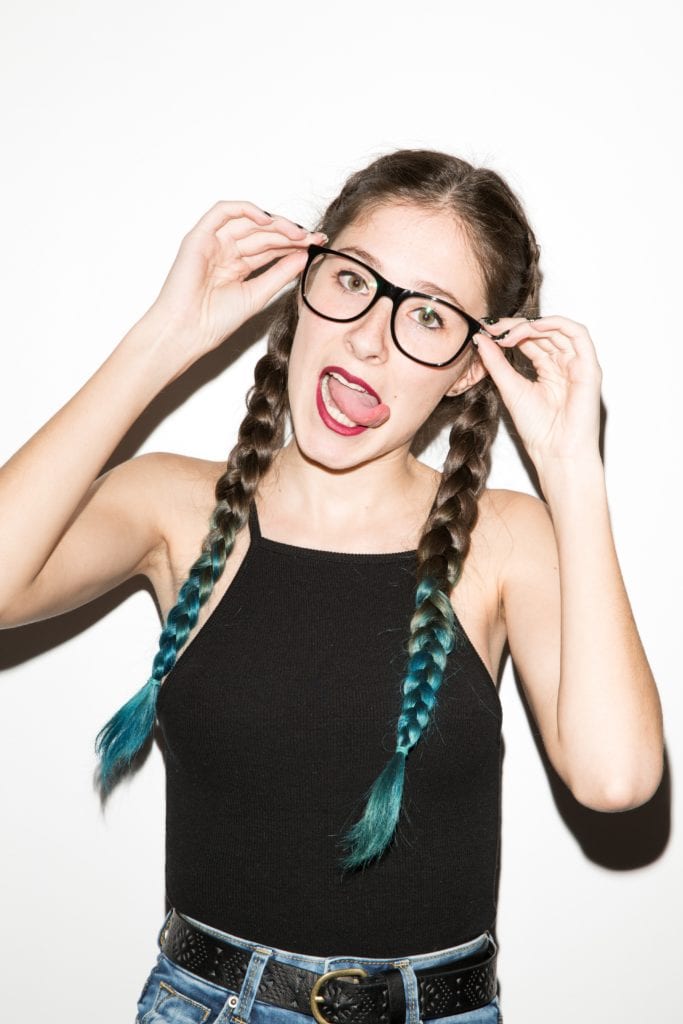 Braided Hair of a girl wearing a casual eye glasses and doing some facial expression