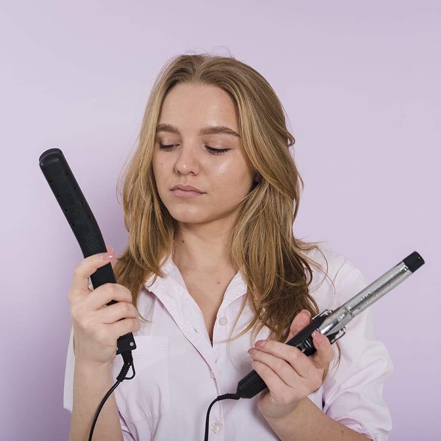 woman choosing between the two best curling iron for fine hair