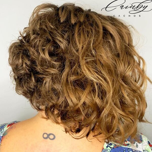A-Line Curl Bob - a woman wearing printed blouse with back tattoo.