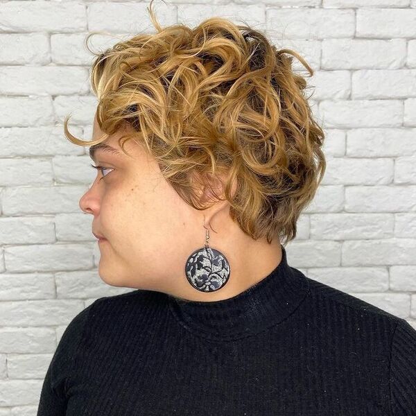 Black Rooted Curly Pixie - a woman wearing black turtle neck top.