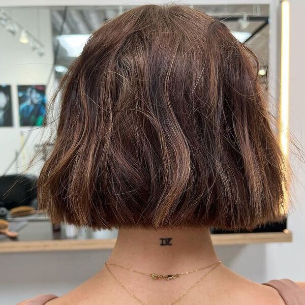 Direct Cut Textured Bob - a woman wearing brown sleeveless top with layered necklace.