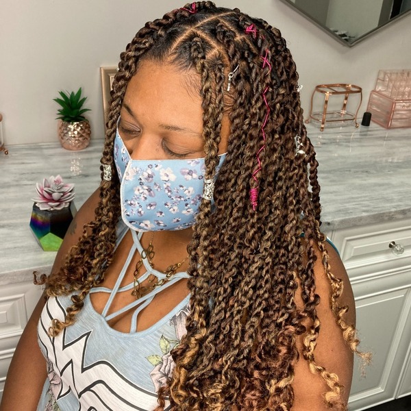 Kinky Twists with Hair Accessories - a woman wearing floral mask and sexy top.