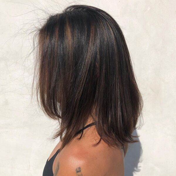 Bouncy Lob with Subtle Highlights -a woman wearing black tank top.