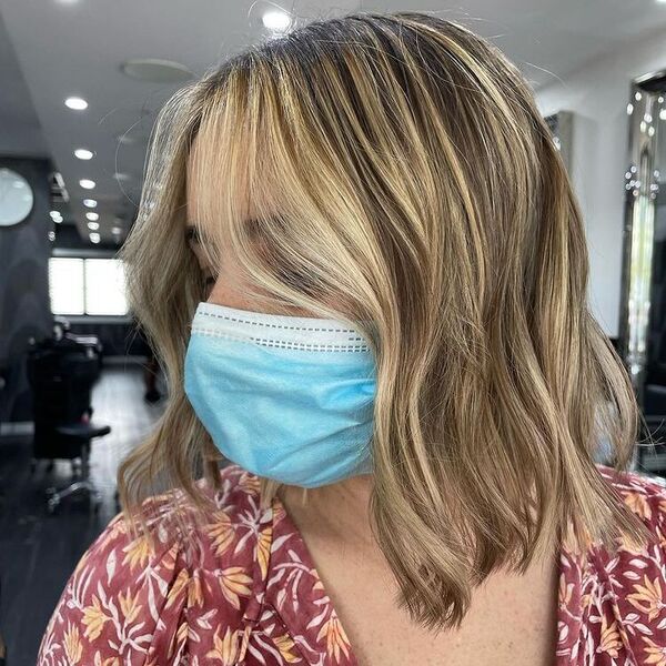 Face Frame Honey Blonde Bob - a woman wearing mask in floral top.