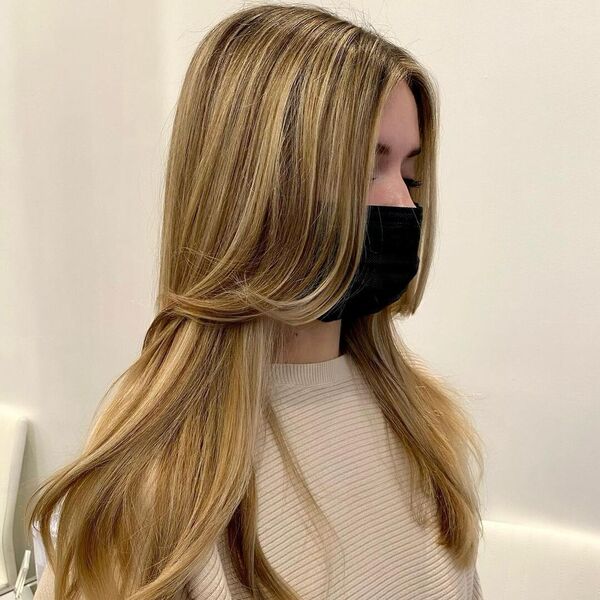 Gorgeous Golden Blonde Balayage - a woman wearing black mask in nude top.
