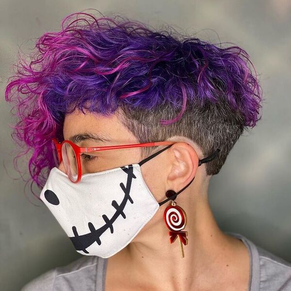 Messy Curl Purple Pink Undercut - a woman wearing light gray shirt with mask and glasses.