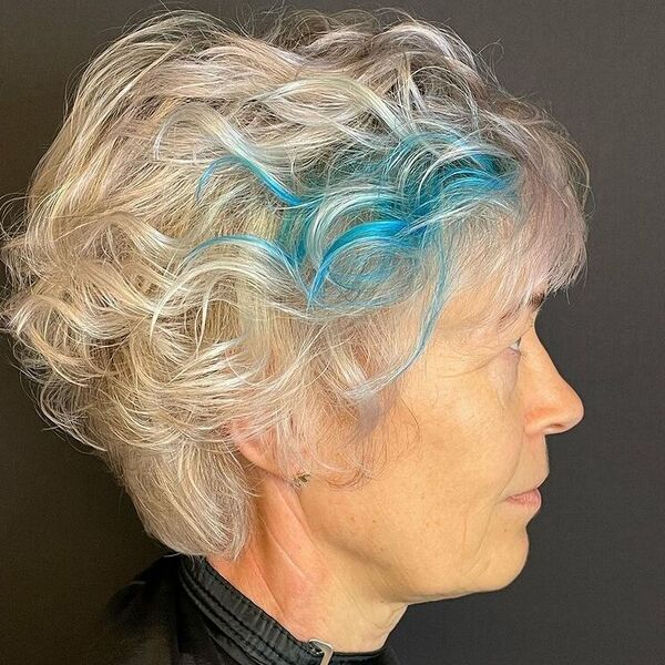 Platinum Feathered Pixie with Blue Streaks - a woman wearing black cape