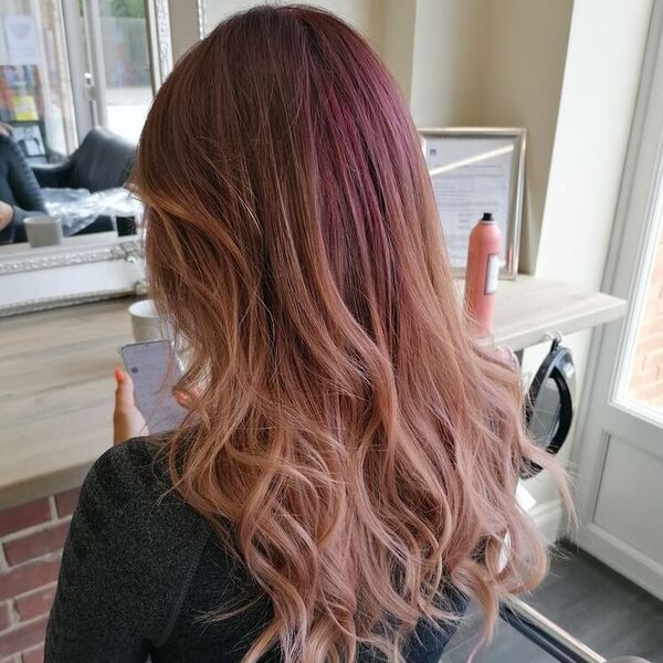 Rose Gold Hair with Purple Highlights - a woman wearing a black longsleeve croptop