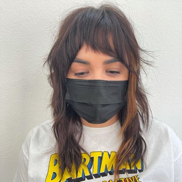 Shaggy Feather Mullet - a woman wearing mask and shirt.