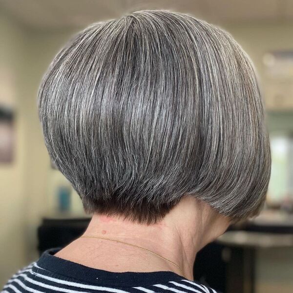 Sleek Straight Silver Wedge Haircut - a woman wearing stripes