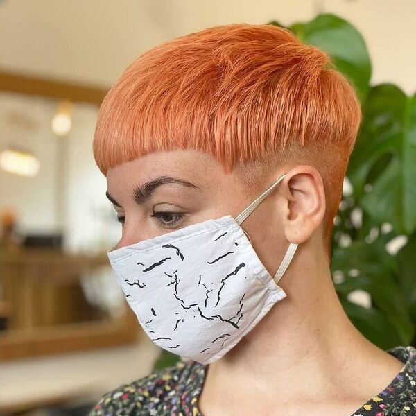 Textured Chop Pixie in Tangerine - a woman wearing mask in floral top.